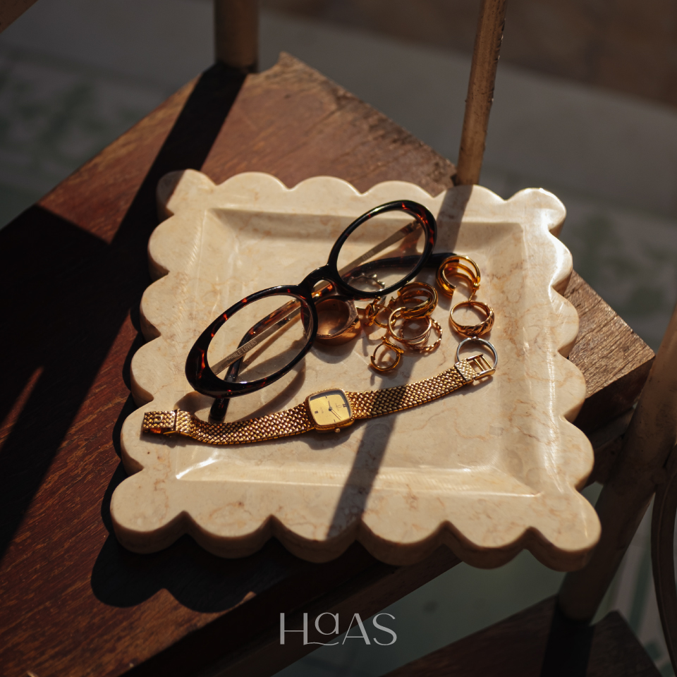 OMBAK natural marble tray with scalloped edges holding glasses and a watch